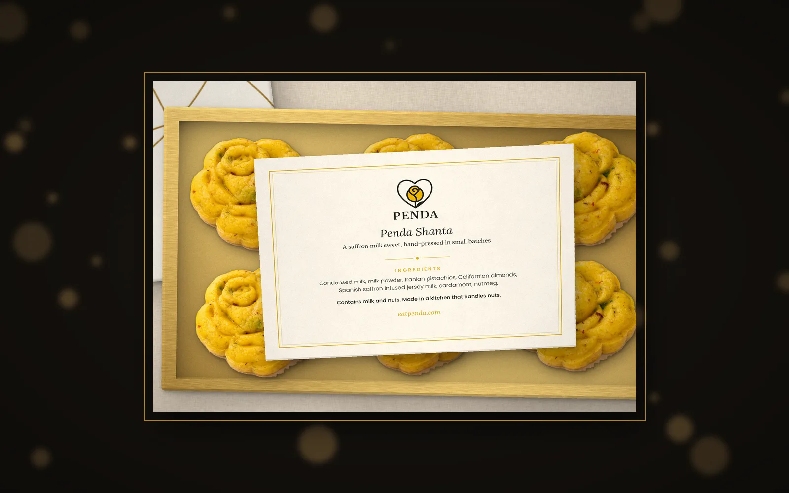 An open Penda box of six on a dark background with warm festive lights