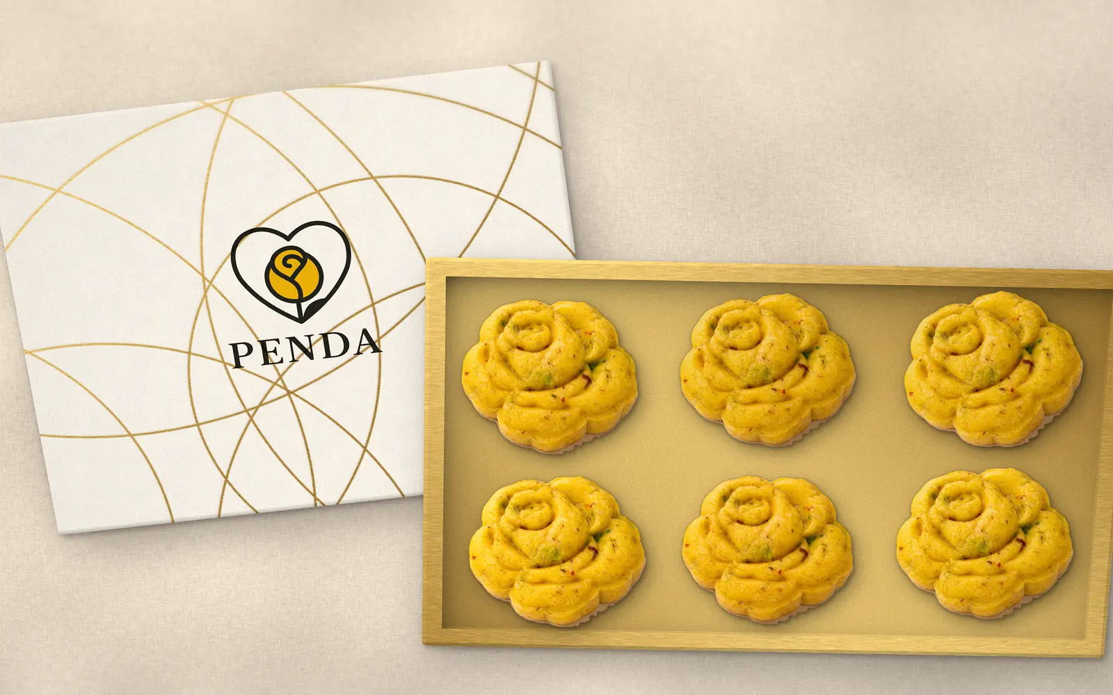 Six Penda saffron milk sweets side by side in a gold box, beside its white and gold lid with the Penda logo